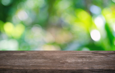 Empty dark wooden table in front of abstract blurred bokeh background of restaurant . can be used for display or montage your products.Mock up for space.