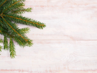 Christmas background with fir branches on brown wooden background. Christmas and New Year concept
