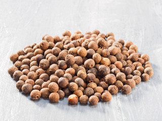 Allspice (Jamaica pepper) on grey background