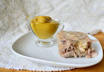 Jelly with meat, beef jelly, traditional Russian dish, serving on a plate, mustard, bread,...