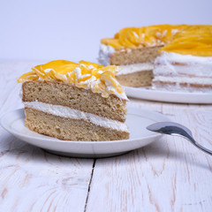 Homemade vegan organic cake. Almond flour and natural cream with mango pieces on top