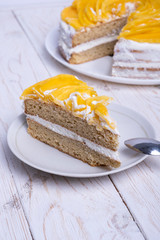 Homemade vegan organic cake. Almond flour and natural cream with mango pieces on top