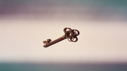 brass key on a light space among shadows