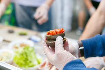 A closeup of the cook is making black hamburger