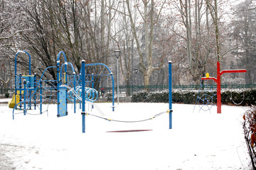 Fototapeta premium snow covered public children playground at winter time