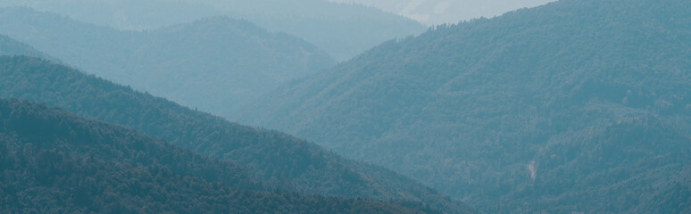 panoramic shot of scenic landscape with green mountains