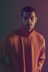 Studio close-up portrait of attractive male model. Color flash studio light