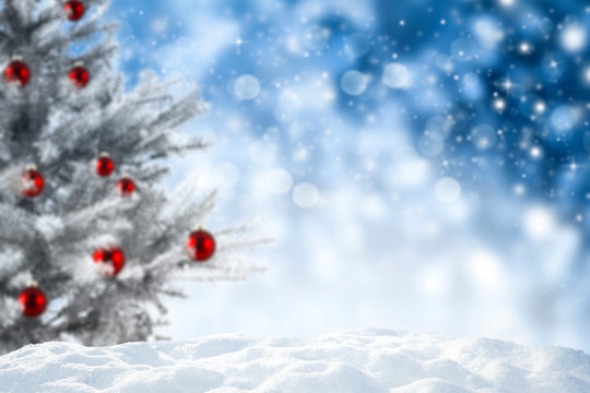 Chrismtas background of snow and free space for your decoration. Blurred space and xmas tree 