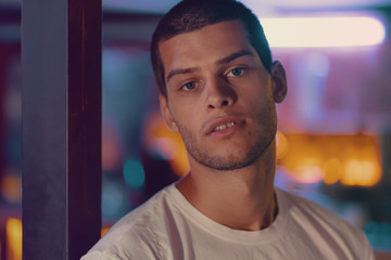 Close-up portrait of attractive male model. Young handsome man in a bar