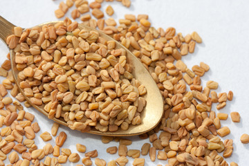 Fenugreek seeds in a spoon.