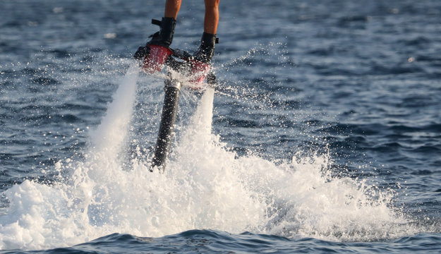 A man on a water attraction at sea
