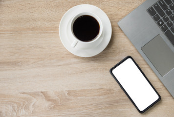 top view coffee cup smartphone and laptop on wooden table background