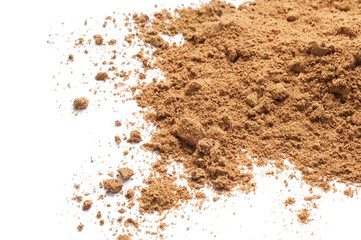 Ground nutmeg isolated on white