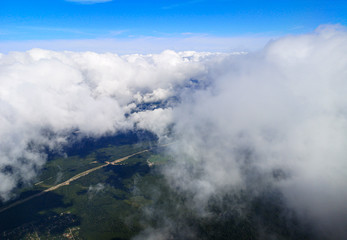Obraz premium Clouds above the ground view from an airplane as a background