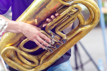 A tuba musician closeup in the city street
