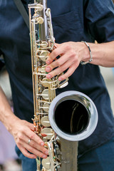 A closeup plane of saxophone player in black shirt