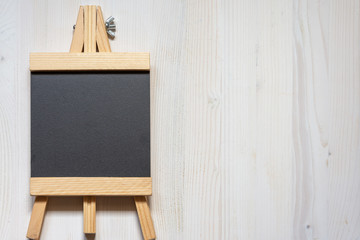 Aerial view of an empty blackboard shaped like an easel on white background with copy space