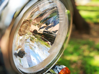 Chromed headlamp of a motorcycle, stylish classic chrome-plated motorcycle headlight.