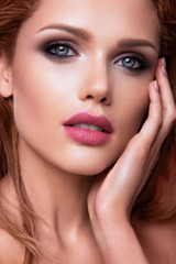 Fototapeta premium Make up. Glamour portrait of beautiful woman model with fresh makeup and romantic wavy hairstyle.