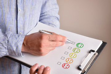 Man marking happy face emoticon drawn on a sheet