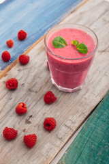 healthy raspberry smoothie on wooden table