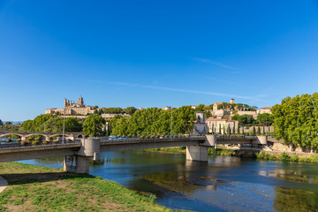 View to Beziers city from the Orb Aqueduct, a bridge which carries the Canal du Midi over the Orb River in the city of Beziers in Languedoc-Roussillon, France.