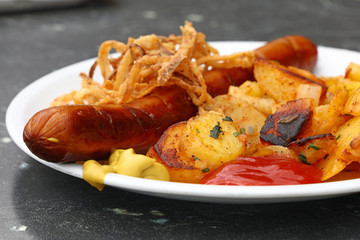 Close up portion of sausage with roasted potato
