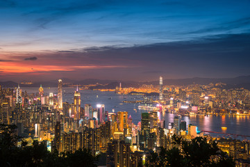 Fototapeta premium Hong Kong city on dramatic sky at sunset view from mountain.
