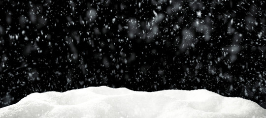 Winter snow flakes with free space for your product. Black background to mount your picture through the screen