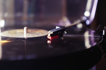 Fototapeta premium Cinemagraph vinyl record spinning. Wide shot close up of needle playing record album on a vintage turntable. Old school record player .retro record vinyl player