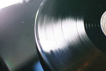 The groves of a vinyl record are shown spinning up close, Close up of vinyl record on DJ turntable , Cinemagraph vinyl record spinning , old school record player