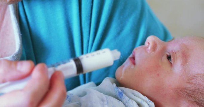 Artificial feeding of the child with a syringe