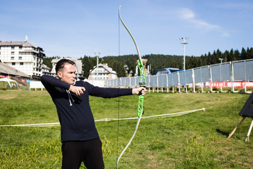 Sportsman practicing archery outdoors.