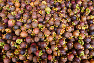 Mangosteen queen of fruit.Healthy fruits mangosteen background, dark mangosteen in a supermarket local market bunch of mangosteen ready to eat, summer and Thailand fruit.