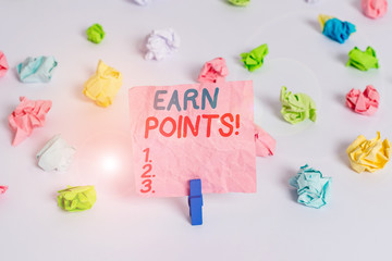 Conceptual hand writing showing Earn Points. Concept meaning collecting scores in order qualify to win big prize Colored crumpled paper empty reminder white floor clothespin