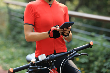 Riding on bike path,using smartphone while riding bike on sunny day