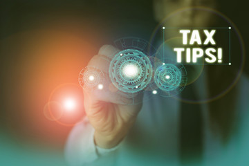 Text sign showing Tax Tips. Business photo showcasing compulsory contribution to state revenue levied by government Woman wear formal work suit presenting presentation using smart device