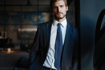 Handsome young businessman in office
