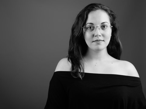 Portrait of young woman wearing eyeglasses shot in black and white