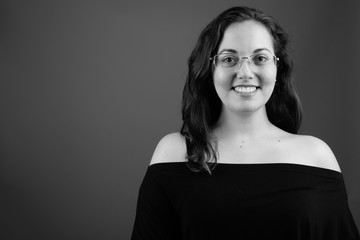 Portrait of young happy woman smiling shot in black and white