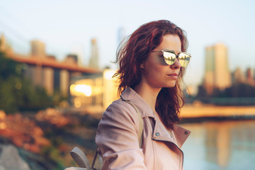 Young girl in sunglasses on the promenade