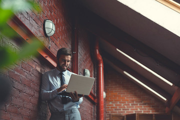 Working young businessman with a laptop