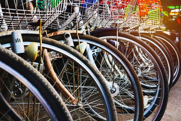 Obraz premium Row bicycle for rent.Detail of wheel Bicycle in line.