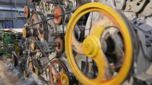 Parts rotation in a factory. Modern factory, working elements. Machine for the production of synthetic winterizer
