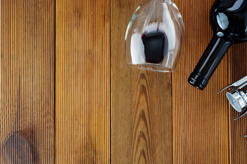 Wine bottle with wineglass corckscrew rustic wooden board, copy space. Flat lay.