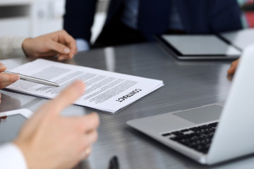 Business people discussing contract working together at meeting at the glass desk in modern office. Unknown businessman and woman with colleagues or lawyers at negotiation. Teamwork and partnership