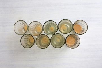 Empty after masala tea glasses on light gray table. Top view, flat lay, copy space