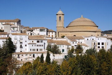 Fototapeta na wymiar View of San Antonio church and whitewashed town buildings, Montefrio, Spain.