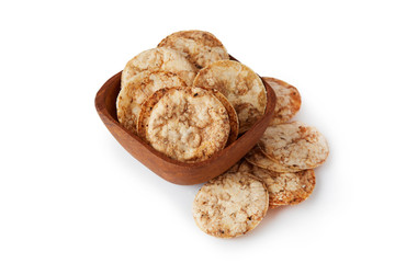 Brown rice chips isolated on white background. Healthy crispy snack