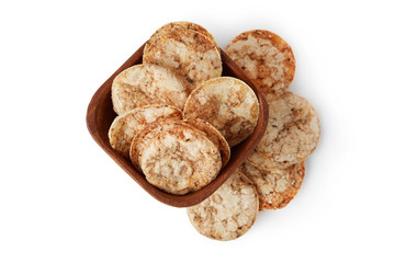 Brown rice chips isolated on white background. Healthy crispy snack